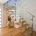 Modern wooden staircase with glass panels in a residential interior.