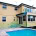 Residential house with pool, balcony, and large windows in Sydney.