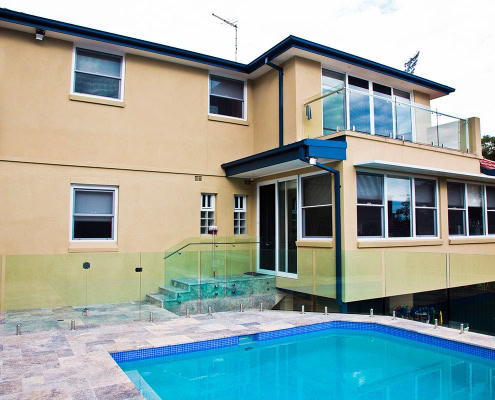 Residential house with pool, balcony, and large windows in Sydney.