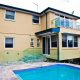 Residential house with pool, balcony, and large windows in Sydney.